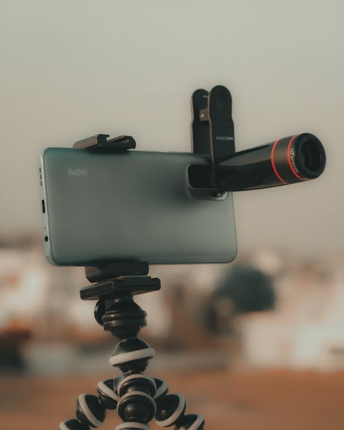 Close-up of a Smartphone on a Tripod with an Attached Lens 