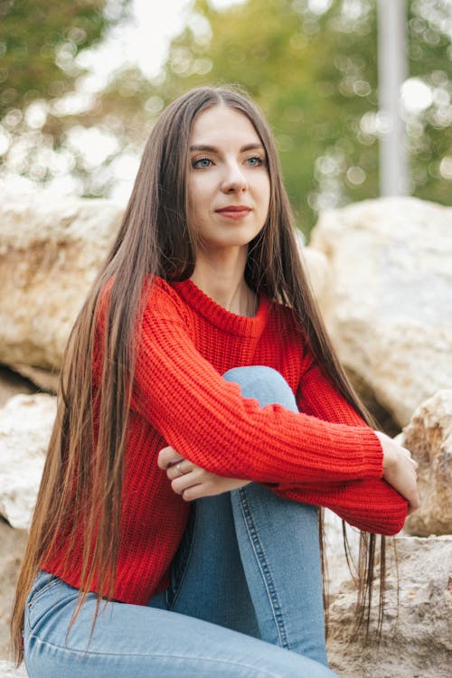 Woman Wearing a Red Sweater and Jeans 