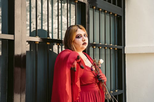 Woman in a Red Dress and Halloween Makeup 