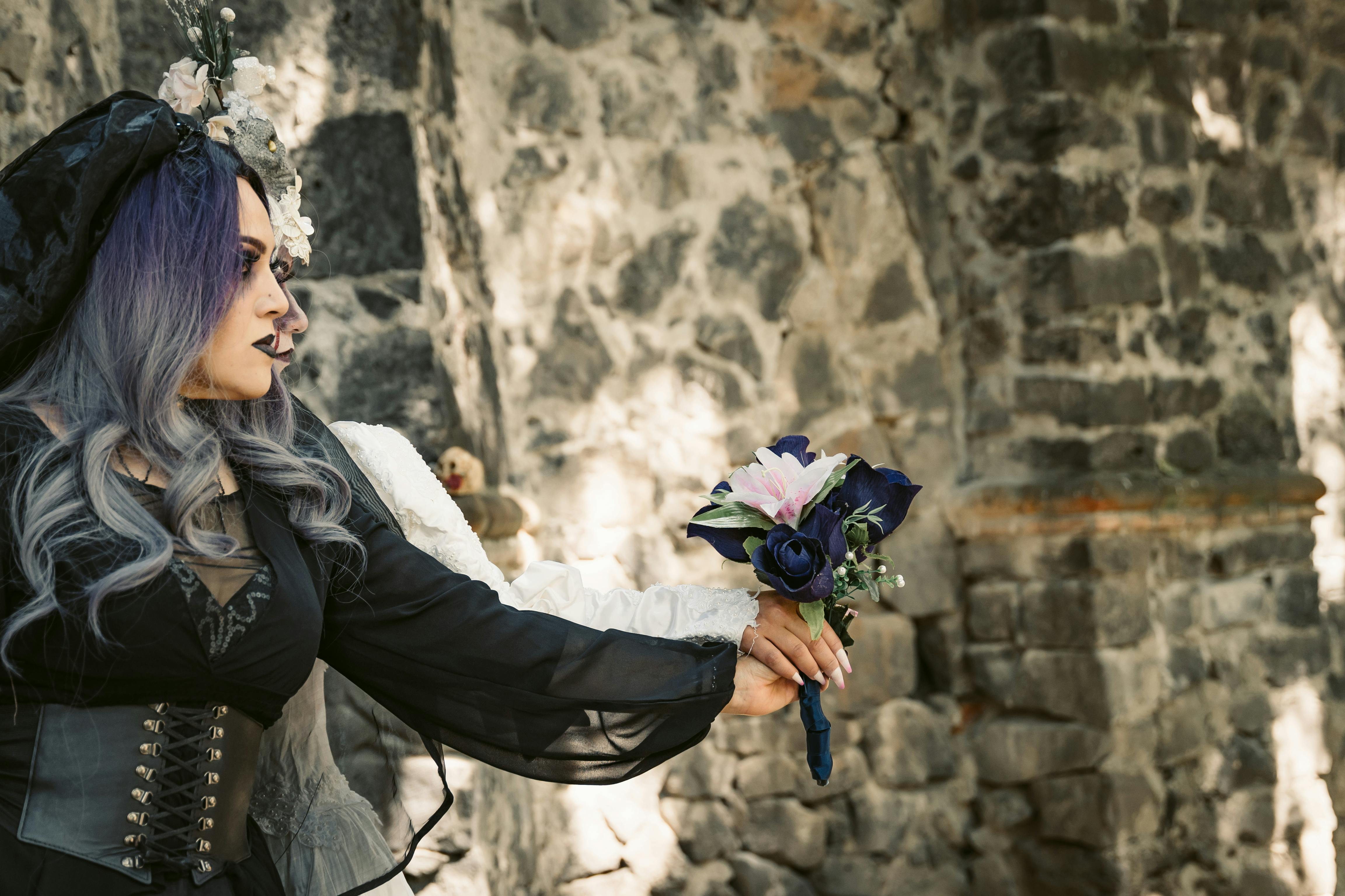 Women in Black and White Halloween Costumes Holding a Bouquet · Free Stock  Photo