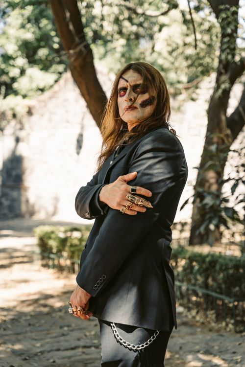 Free A man with scary Halloween face paint and a suit poses outdoors in Mexico City. Stock Photo