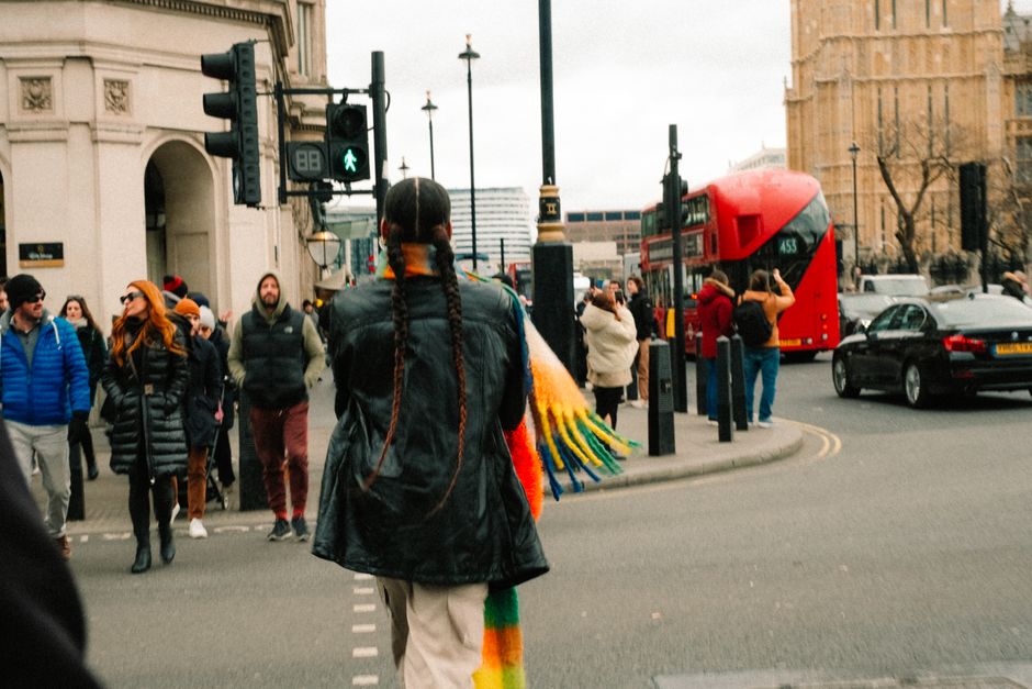 Vibrant city scene in London featuring pedestrians and iconic red double-decker bus.
