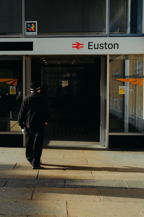 Man Walking Towards Euston Station Entrance