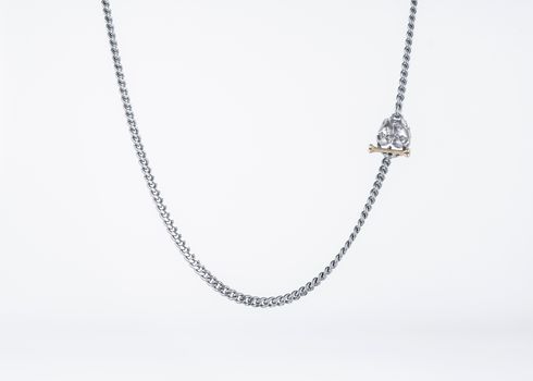 Detailed image of a stylish silver Cuban link chain necklace with a bulldog pendant on a white background.