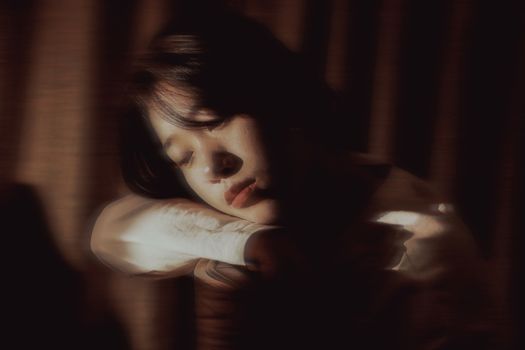 Young Woman Leaning her Face on the Elbow 