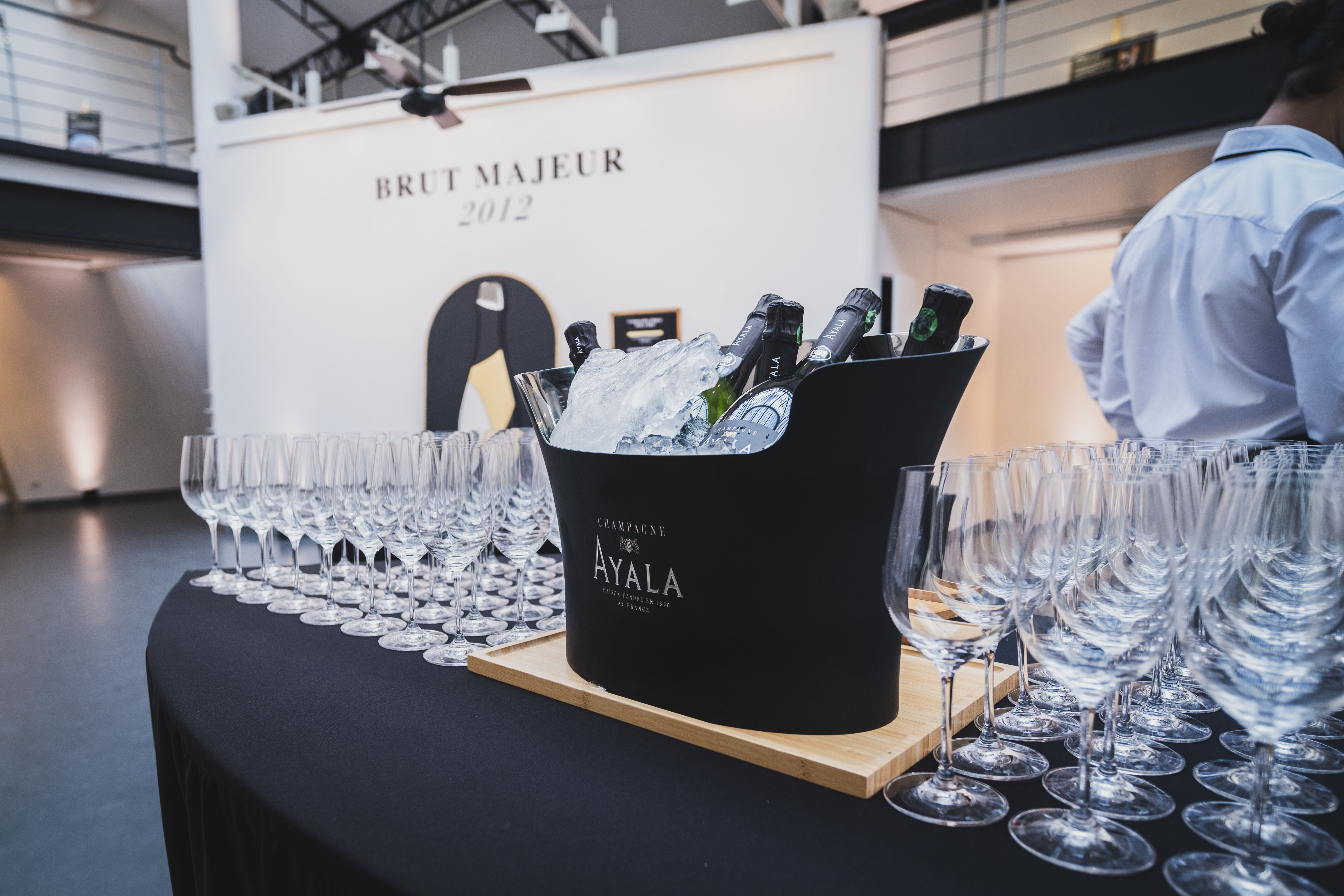 Chic champagne setup with ice bucket and glasses at a sophisticated event.