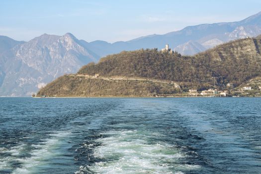 Tranquil panoramic view of Lake Iseo with mountainous backdrop in Lombardia, Italy.
