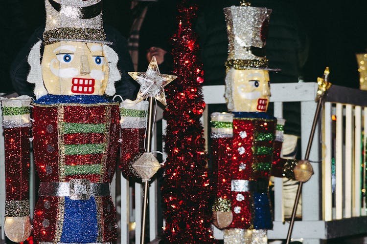 Two Nutcracker Figurine Near Fence