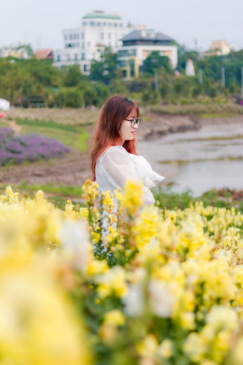 Woman Posing among Flowers