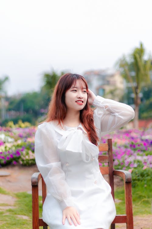 Smiling Woman in White Dress