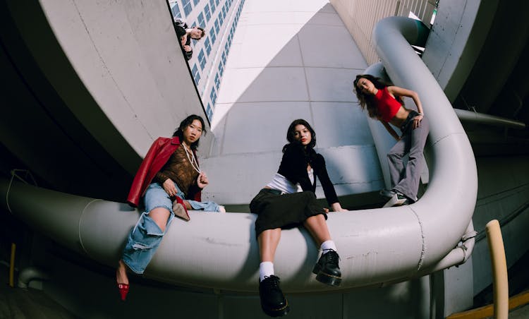 Women Posing On A Pipe