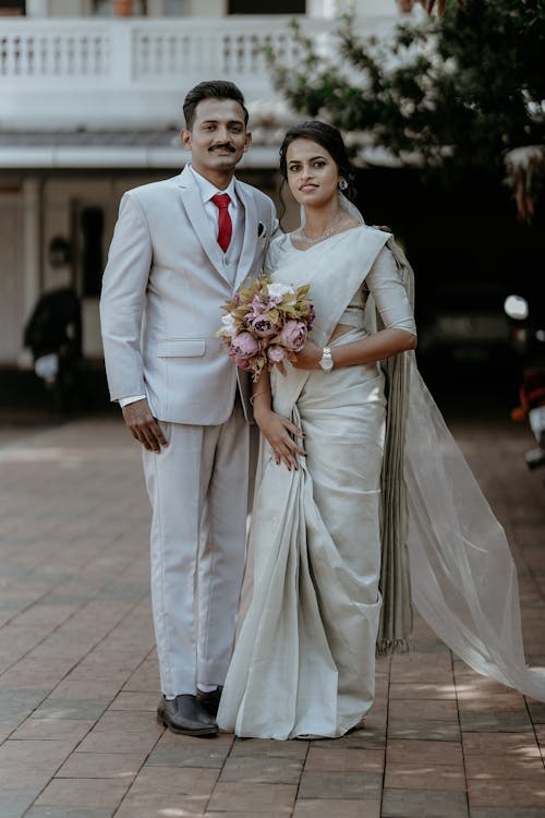 Bride and Groom Smiling and Posing Outdoors 