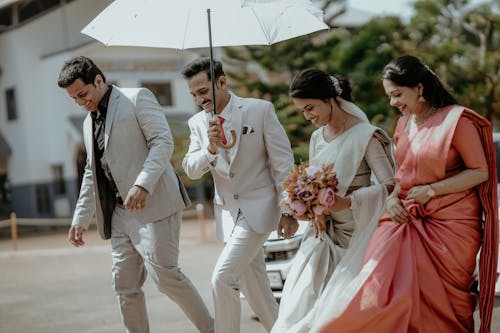 Smiling Women and Men with Umbrella