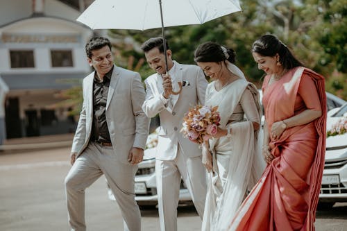 Bride and Groom Walking Together with the Bridesmaid and Best Man 