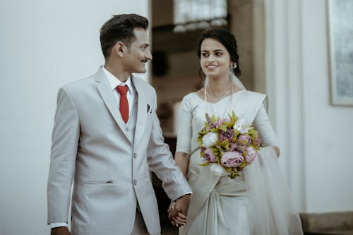 Woman and Man in Wedding Dress and Suit