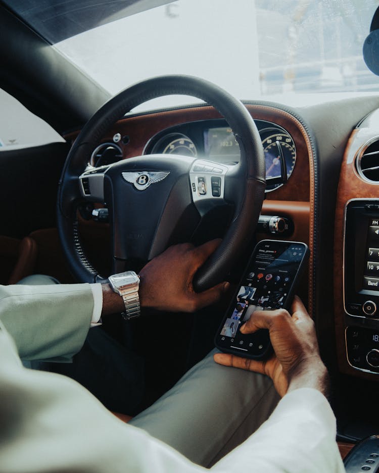 Man Using Phone While Driving A Car