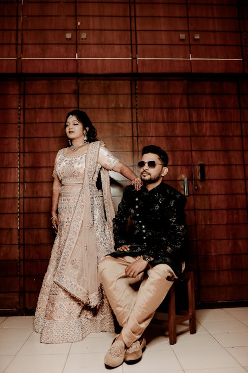 Woman and Man Posing in Traditional Clothing