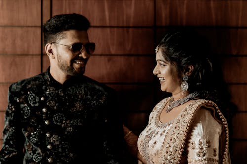 Smiling Woman and Man in Traditional Clothing