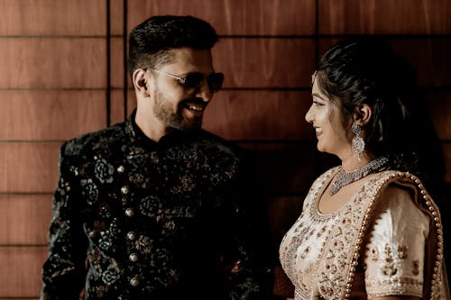 Smiling Man and Woman in Traditional Clothing