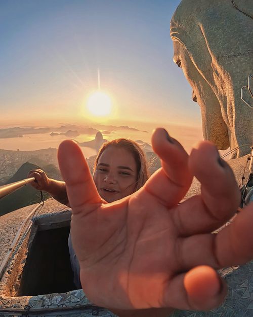 Free Capturing a selfie at Christ the Redeemer statue with a stunning sunset view in Rio de Janeiro. Stock Photo