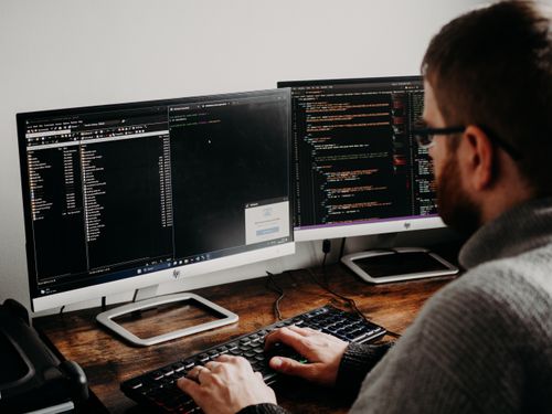 Man Coding on PC ยท Free Stock Photo