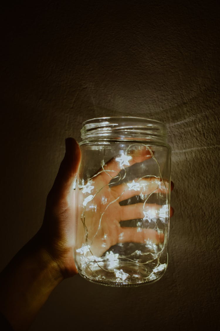 Hand Holding Illuminated Jar