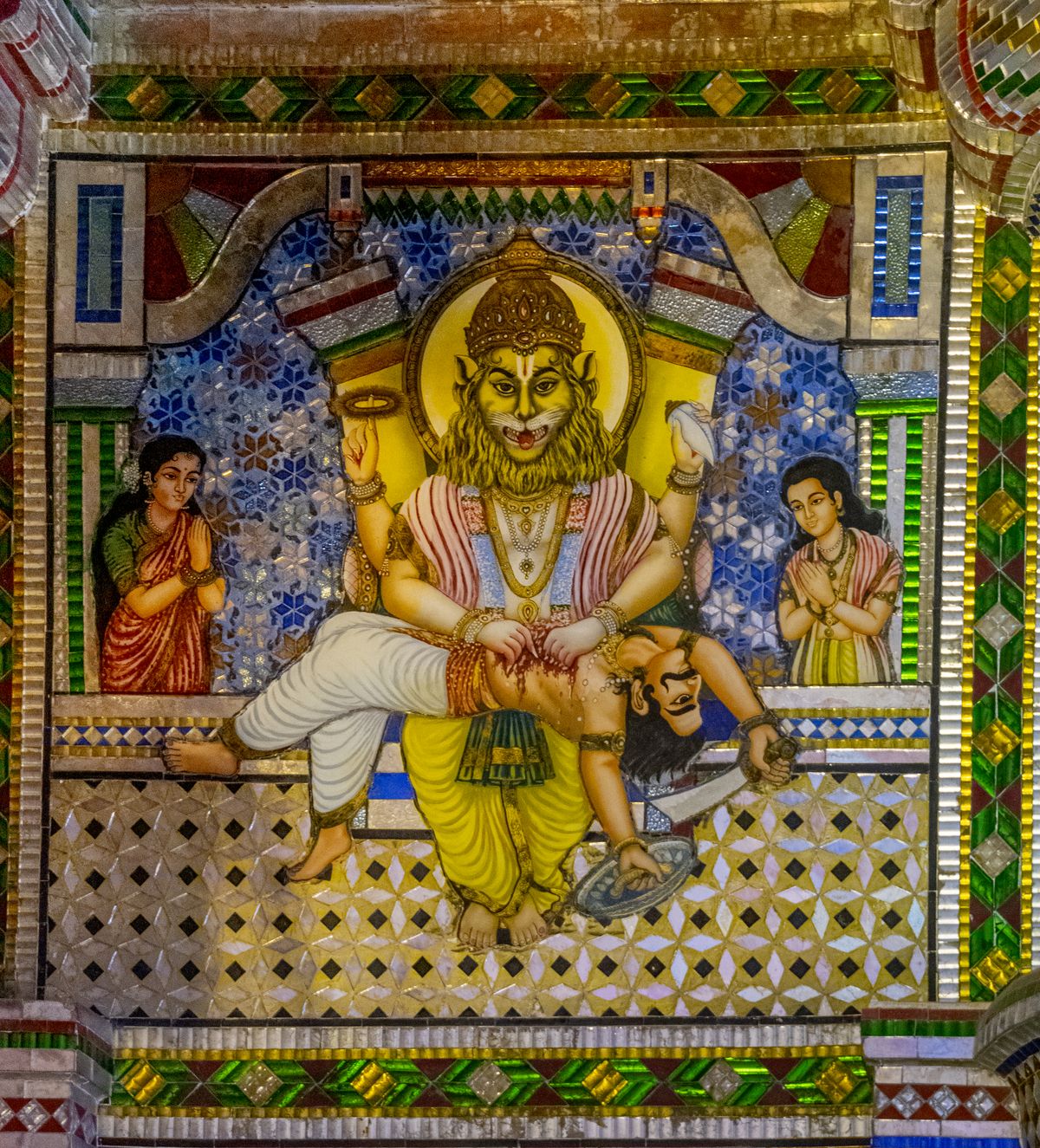 Colorful Indian temple mural depicting a mythological deity figure with fine linework