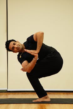 Adult man in yoga pose on mat indoors, embracing mindfulness and vitality with yoga practice.