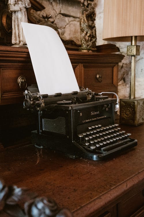 Free Vintage Smith-Corona Silent Typewriter on Retro Furniture Stock Photo