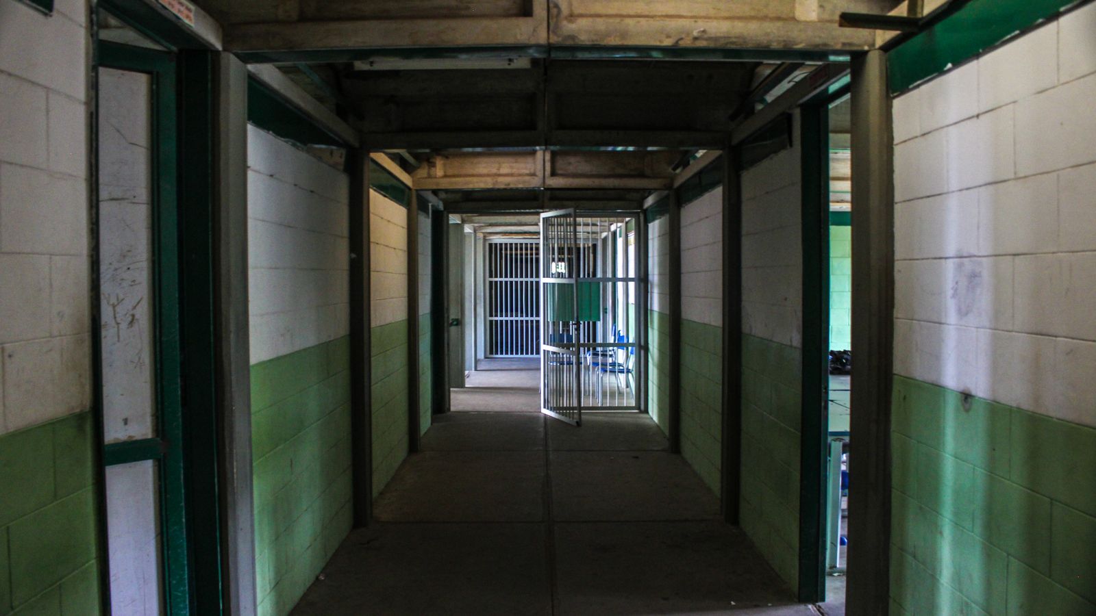 Empty prison corridor with open cell doors and no people in the frame, a real stock photo chosen because The New Stanford Prison Experiment puts 30 volunteers inside a real detention center. It is not a still from the show and it does not show the Georgia facility used for the series