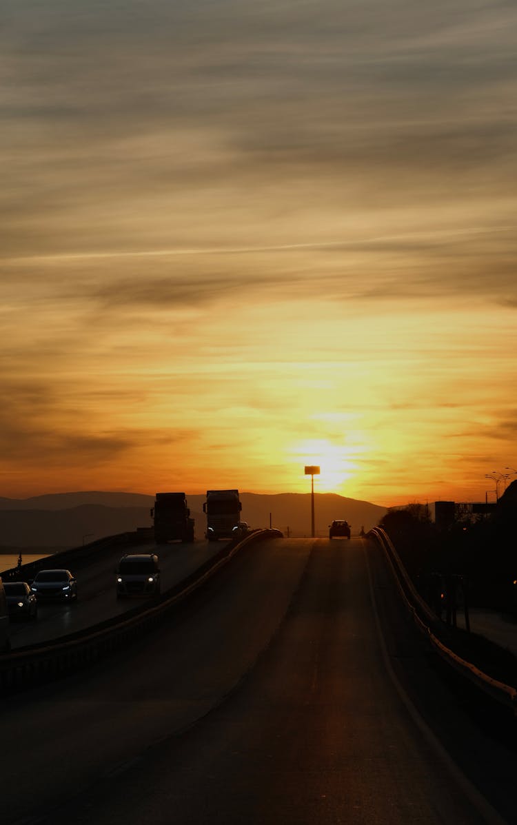 Cars On A Highway At Sunset