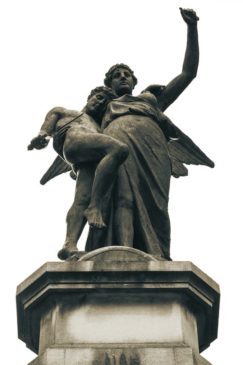 Free Elegant stone angel sculptures in Recoleta Cemetery, a notable Buenos Aires landmark. Stock Photo