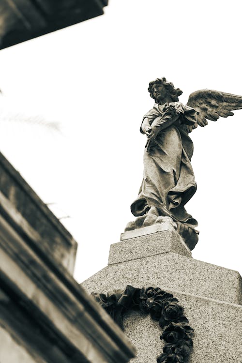 Free Low Angle Shot of an Angel Statue on a Tomb in the Recoleta Cemetery, Buenos Aires, Argentina  Stock Photo