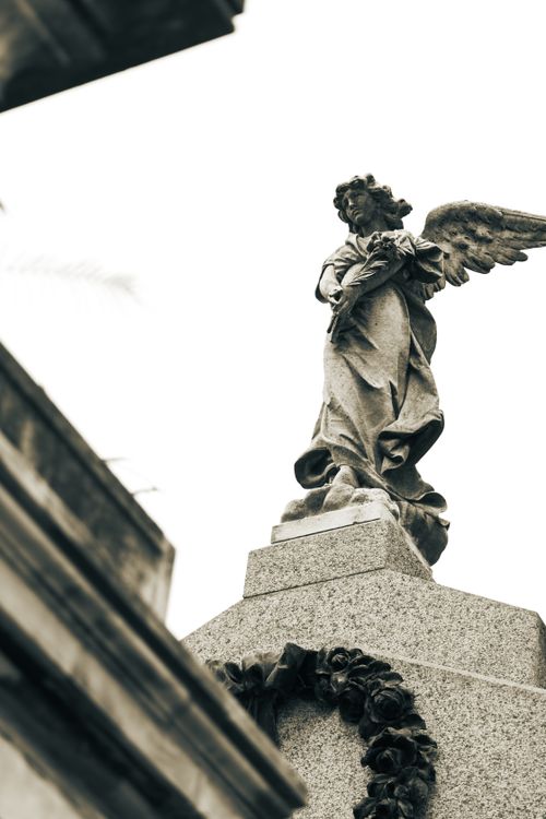 Free Low angle view of an angel statue at Recoleta Cemetery, Buenos Aires, capturing its intricate details. Stock Photo