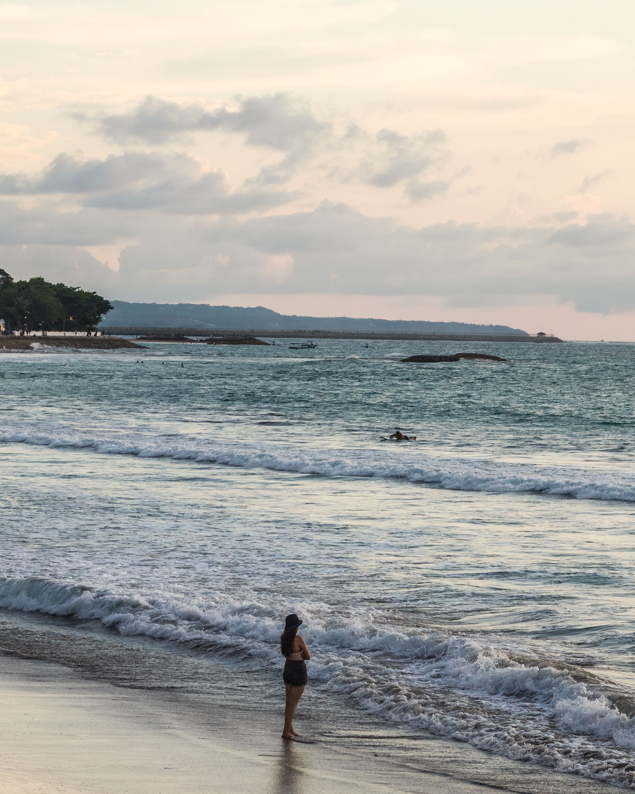 Young Woman Standing on a Beach and Looking at a View of Sea · Free ...