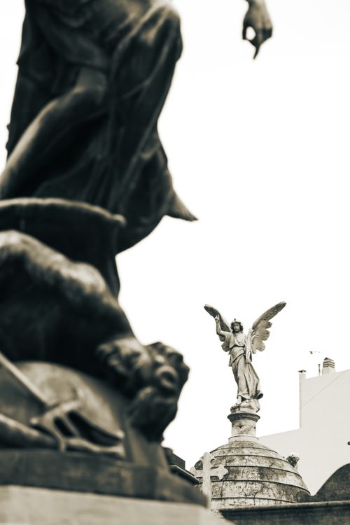 Free Elegant black and white capture of angel sculptures in a Buenos Aires cemetery. Stock Photo