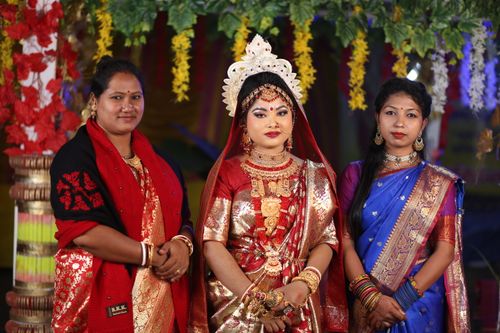 Free A stunning bride in traditional Bengali attire poses with two women in colorful sarees. Captured in Panchagarh, Bangladesh. Stock Photo