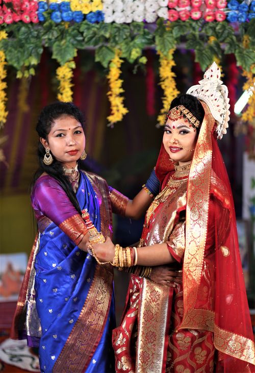 Free Two women in traditional attire celebrate a vibrant South Asian wedding in Panchagarh, Bangladesh. Stock Photo
