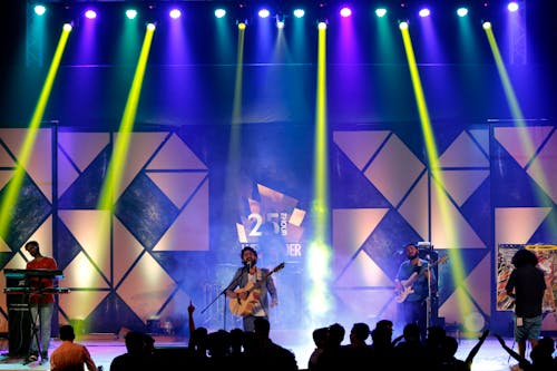 Man Playing Guitar Singing On Stage