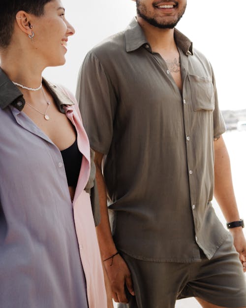 Man and a Woman Wearing Button Down Shirts Talking to Each Other