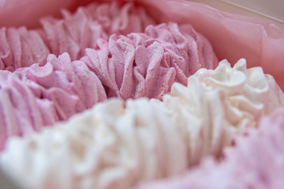 Delicious handmade pink and white zephyr marshmallows in a close-up view.