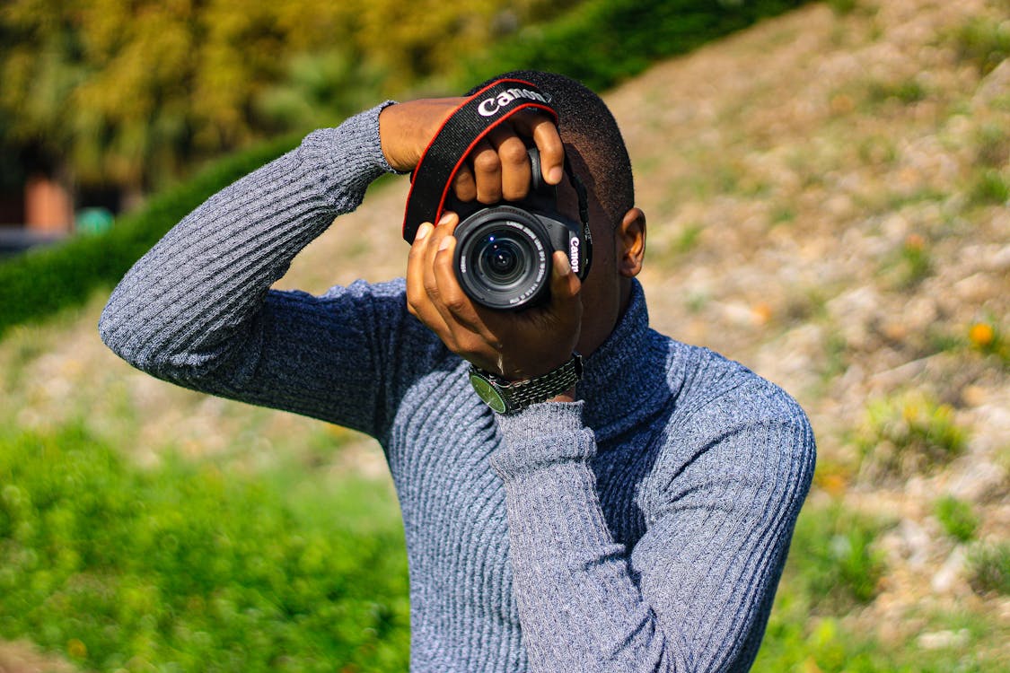 Man Photographing with an SLR Camera 