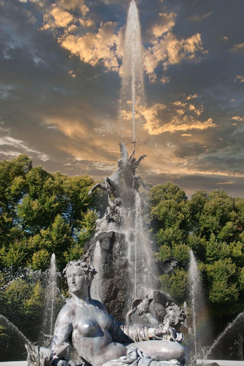 Ornate Fountain Splashing against a Cloudy Sky