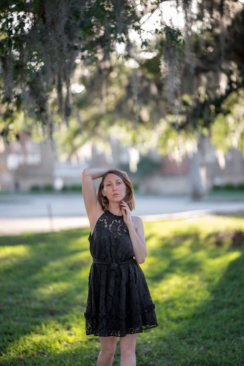 A beautiful young woman in a black dress posing for a photo · Free ...