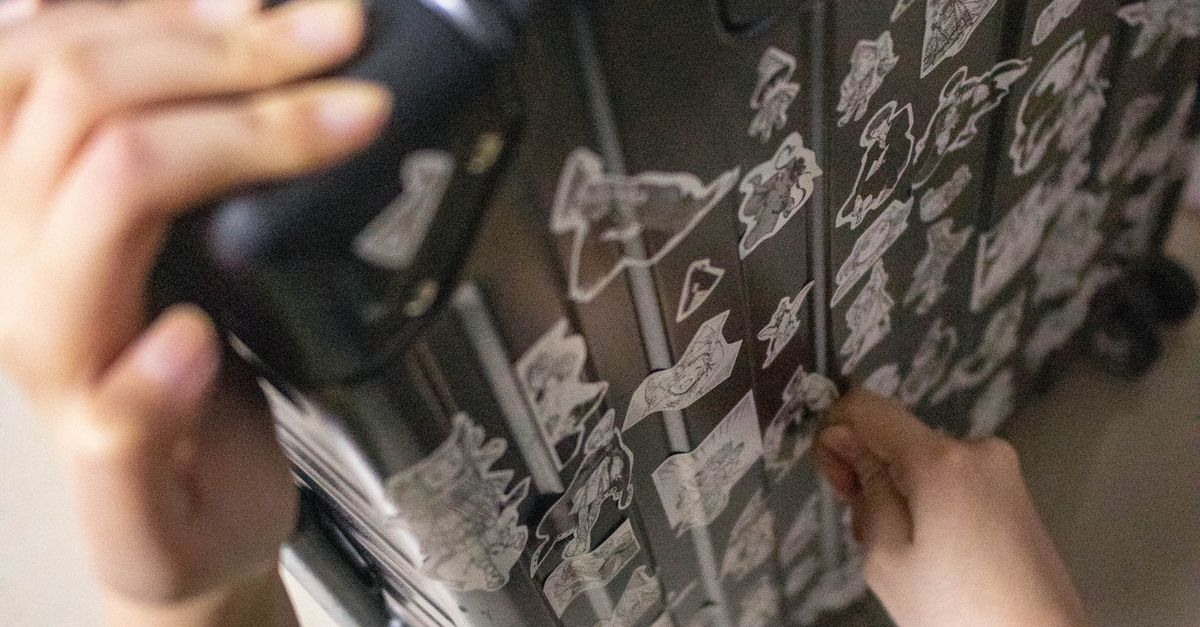 People Using Stickers Person Placing Stickers on Suitcase · Free Stock Photo