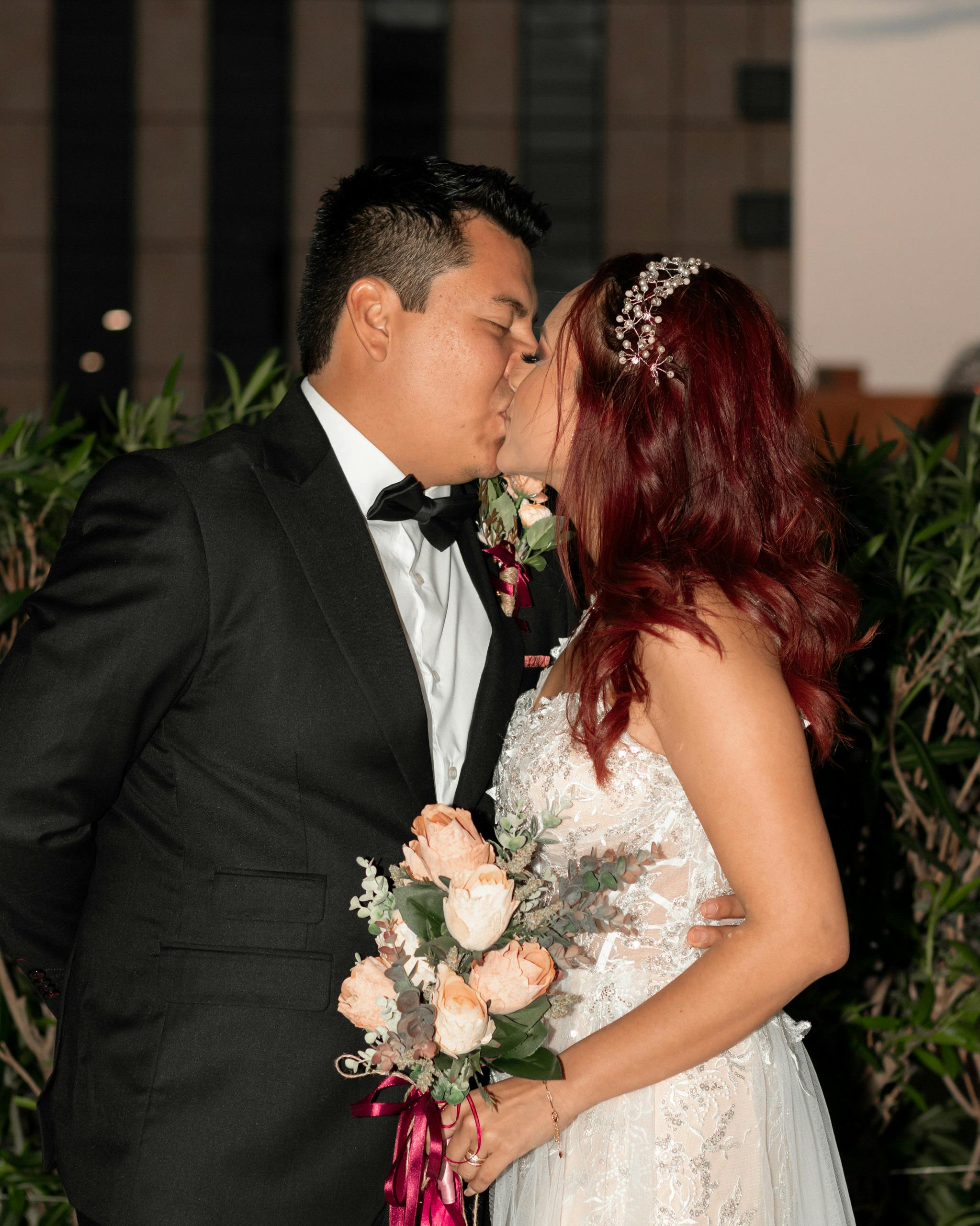 newlyweds standing and kissing