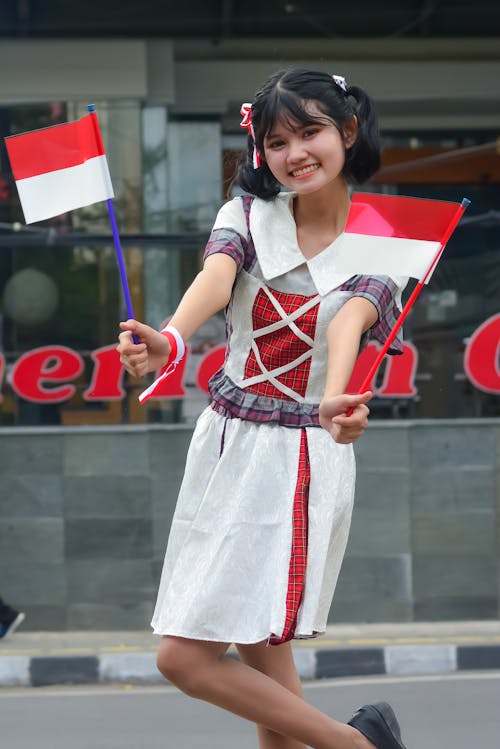 Free Smiling Young Woman with Flags of Indonesia Stock Photo