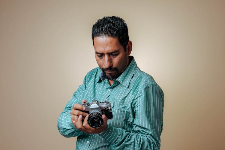 Man With A Mustache Looking Down At A Camera