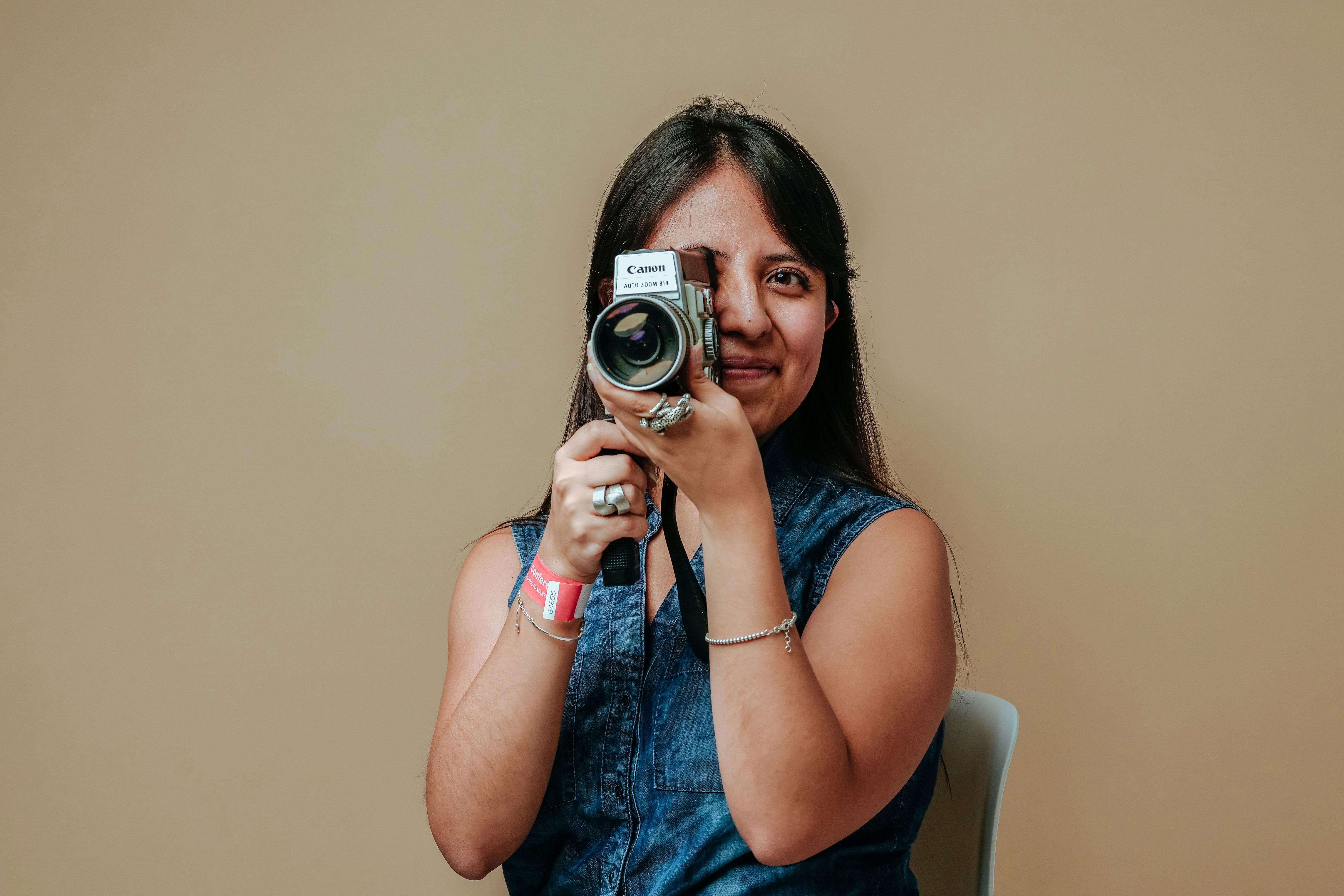 smiling woman with a fringe recording a video