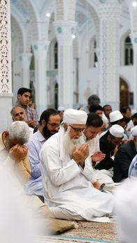 A group of devout men praying inside a beautifully adorned mosque in Khaf, Iran.